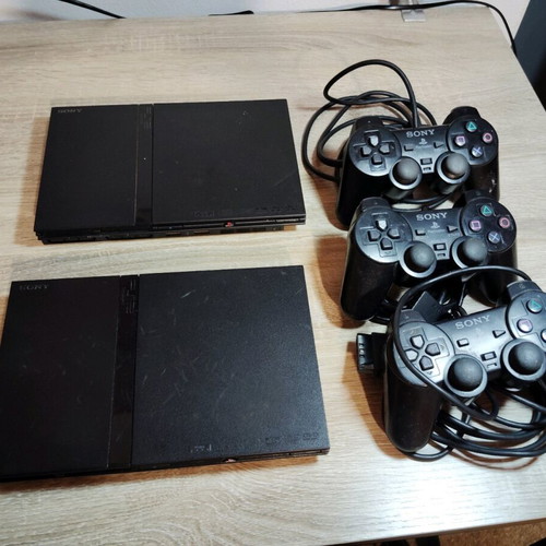 PlayStation 2 Slim used with three controllers for parts