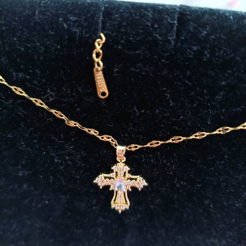Women's cross new in gold color with white zircon stones