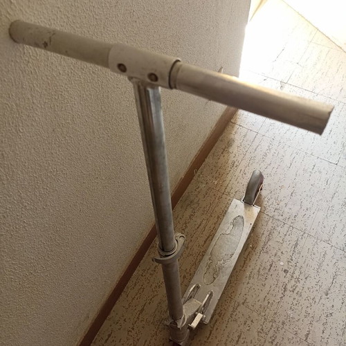 Silver metal scooter used, lightweight and foldable