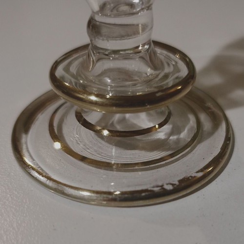 Glass perfume bottle used with golden accents and cap