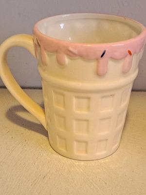 Ceramic mug designed as ice cream cone with pink glaze and sprinkles