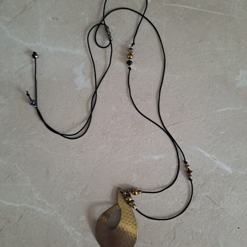 Pendant with adjustable strap and thin copper leaf design