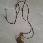 Pendant with adjustable strap and thin copper leaf design