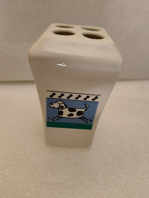 Ceramic pencil holder used with dog design