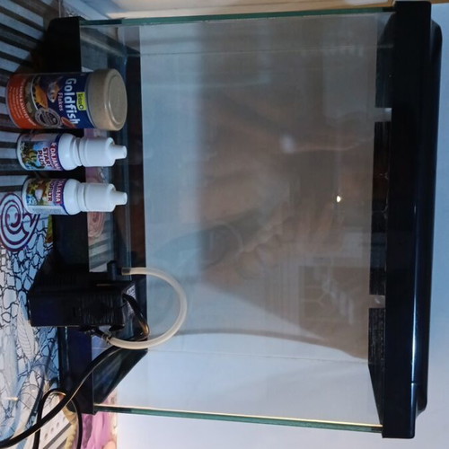 Aquarium 15 liters used with filter, food, and health bottles