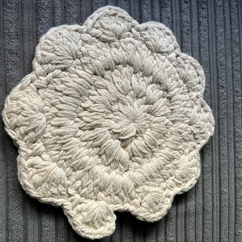 Knitted coaster used, flower-shaped, beige
