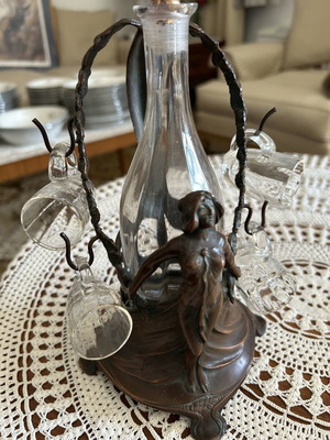 Carafe with metal base and five glasses used