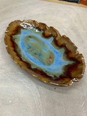 Decorative home ornament with blue and brown tones and bronze details