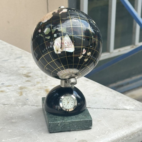 Decorative globe made of semi-precious stones with clock and marble base used
