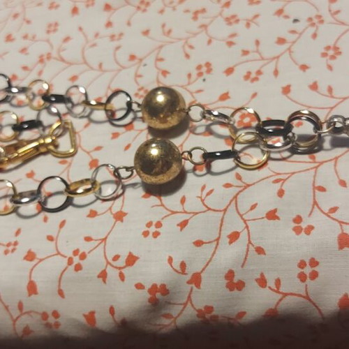Necklace used, plastic silver with black and gold