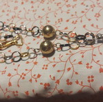 Necklace used, plastic silver with black and gold
