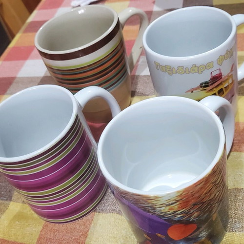 Coffee mugs used, set of 4 with designs and Nava brand