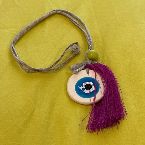 Necklace with clay eye used, handmade with fuchsia tassel