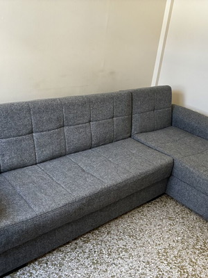Corner sofa bed with storage compartments