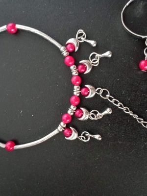Bracelet with integrated ring with red beads used