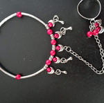 Bracelet with integrated ring with red beads used