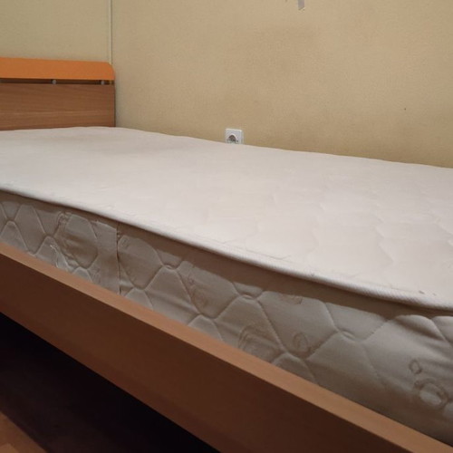 Neoset single bed used with mattress, blue and orange details