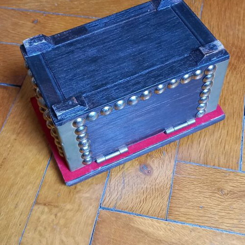 Decorative small wooden chest used with metal details