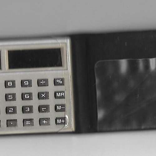 Casio SL-702c solar pocket calculator used with leather case