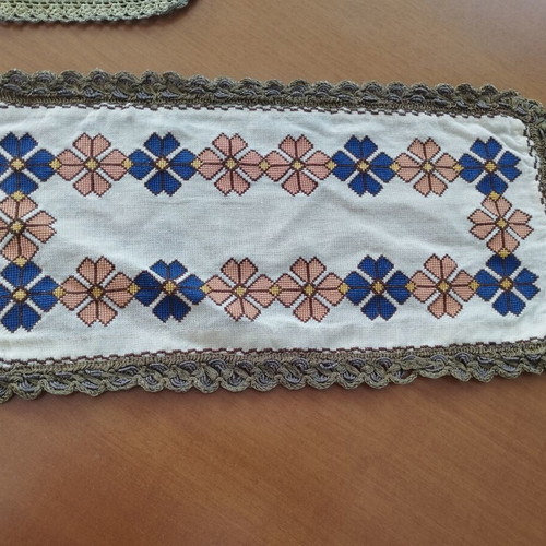 Vintage handmade embroidered table linens with cross-stitch and gold thread