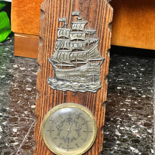 Vintage nautical wall thermometer with wooden base and sailboat