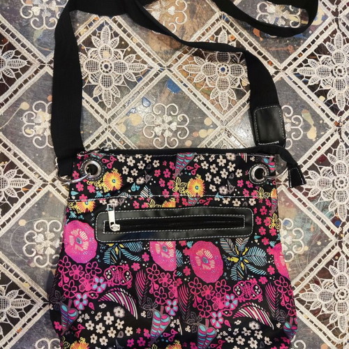 Crossbody fabric bag with colorful floral pattern, black background