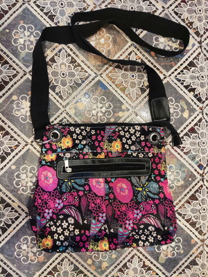 Crossbody fabric bag with colorful floral pattern, black background