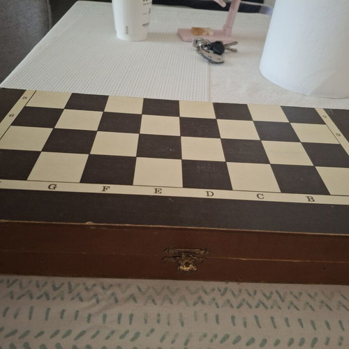 Backgammon and chess board used, missing chess pieces