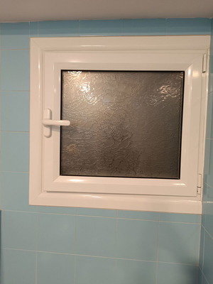 Aluminum bathroom window like new with screen, opens in tilt