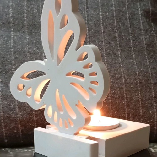 Decorative candle holder with butterfly design in white porcelain powder