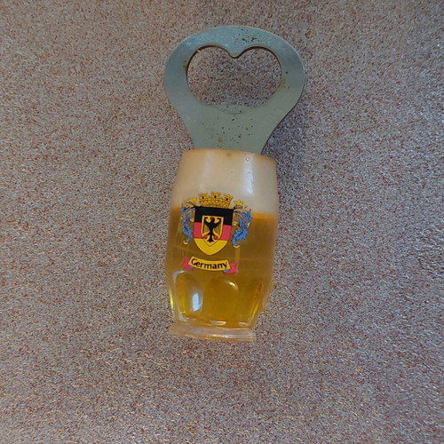 Decorative bottle opener used with wear around the magnet