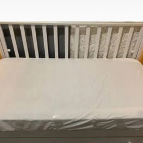 Children's cot and mattress used with drawer and adjustable rails