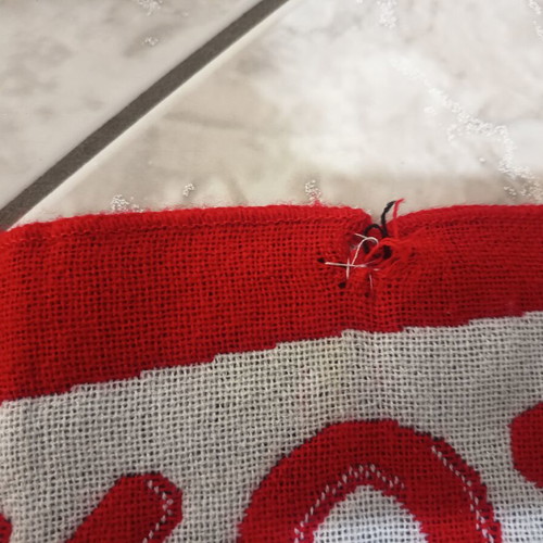 Real Madrid and Olympiakos accessories used with flag, scarf, and cap