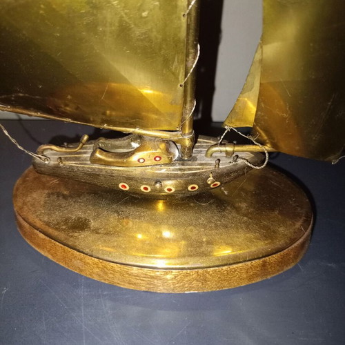 Vintage brass sailboat sculpture on wooden base, used