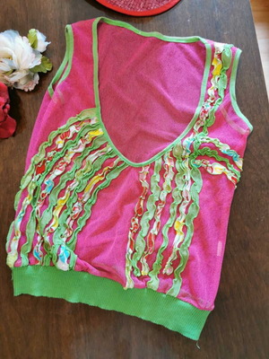 Bright pink mesh top with ruffles and deep V-neck