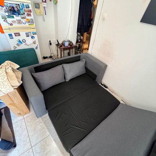 Two-seater grey sofa bed
