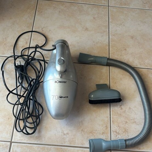 Handheld vacuum cleaner with accessories and cord