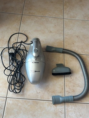 Handheld vacuum cleaner with accessories and cord