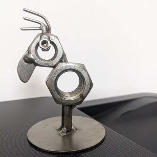 Decorative bird new made from metal nuts