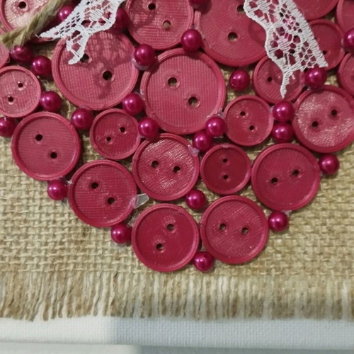Handmade frame new with heart of buttons on canvas