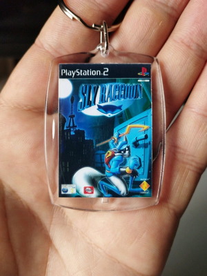 Keychain with Sly Raccoon PS2 cover, transparent acrylic
