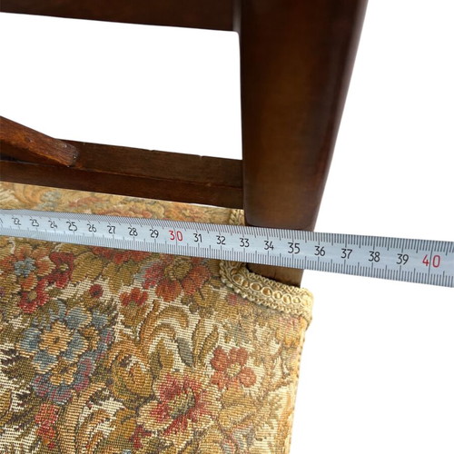 Wooden stool with carved high arms