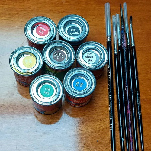 Various jars with colors and brushes