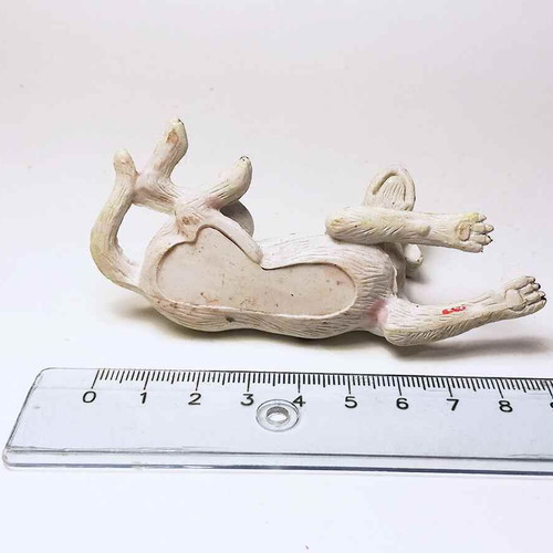 Plastic dog figure used with scratches and marks