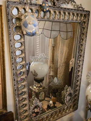 Metal wall mirror used with ornate design