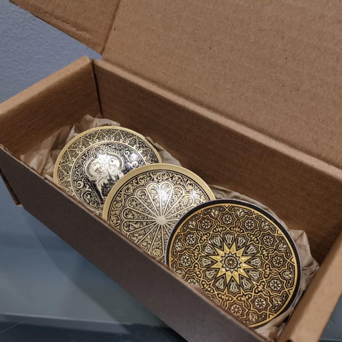 Set of three used metal candle holders with Arabic designs