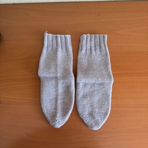 Handmade woolen socks in soft light blue color, new