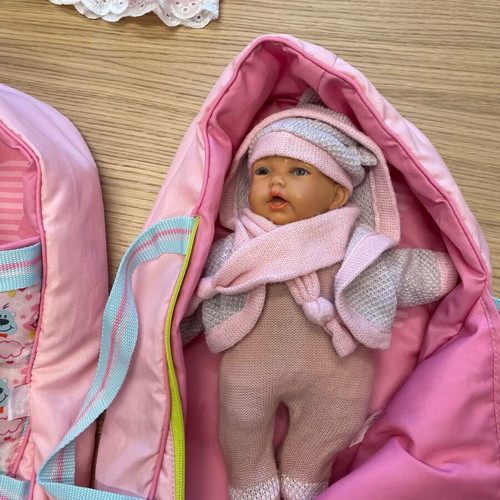 Baby doll like new vinyl with sleeping bag and knitted clothes