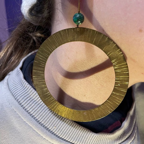 Handmade earrings used, round flat with green bead decoration