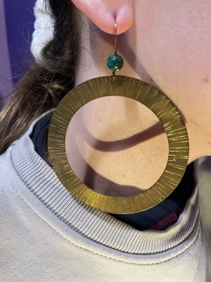 Handmade earrings used, round flat with green bead decoration